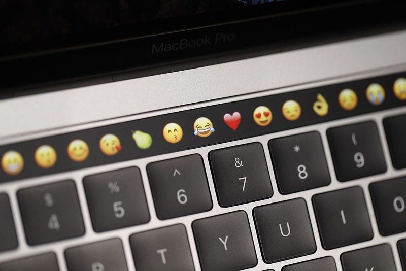 Emojis on a new Apple laptop during a product launch event
