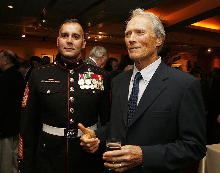 Military Technical Advisor Sgt. Major James Dever, USMC (Ret.) (L) and actor/director Clint Eastwood pose at the afterparty for the premiere of Paramount's