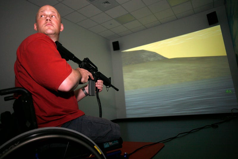Navy vet Chad Keuser uses a mock M4 assault rifle in simulator at the new high tech Center for the Intrepid rehab center for wounded veterans at Brooke Army Medical Center March 1, 2007 in San Antonio, Texas.