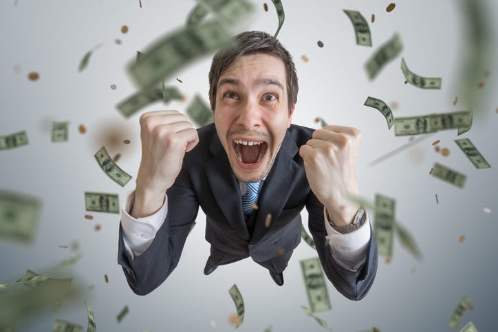 Young successful businessman win a lot of money.