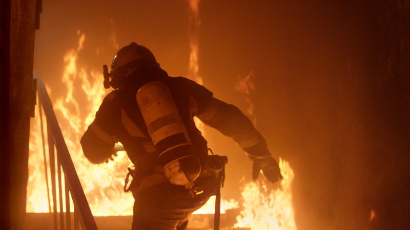 Photograph of firefighter inside a burning building