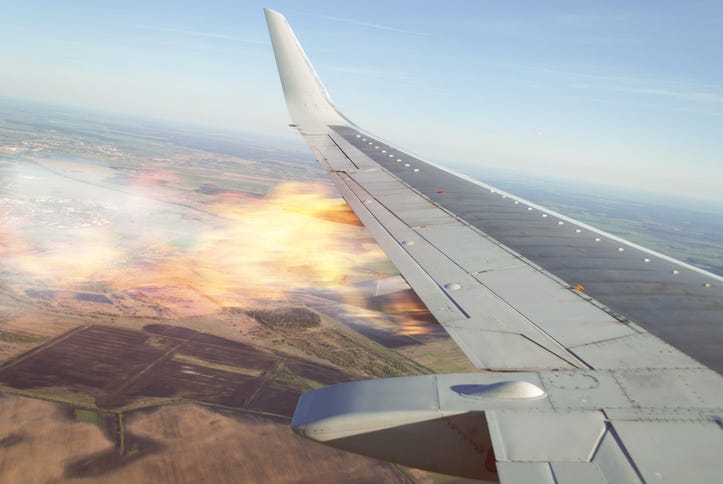 Burning wing of the plane, the plane falling, the view from the window of the aircraft, the emergency situation on Board a passenger liner
