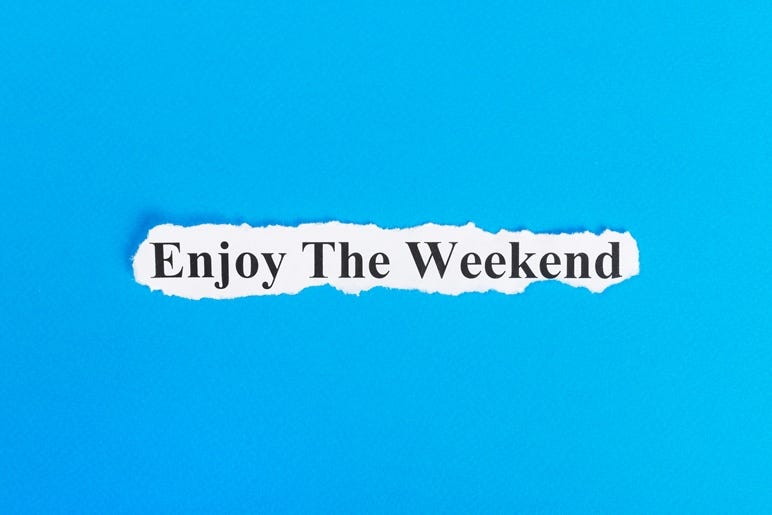 enjoy the weekend text on paper. Word enjoy the weekend on torn paper. Concept Image.