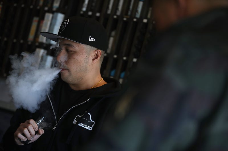 Jeremy Wong blows vapor from an e-cigarette at The Vaping Buddha on January 23, 2018 in South San Francisco, California.