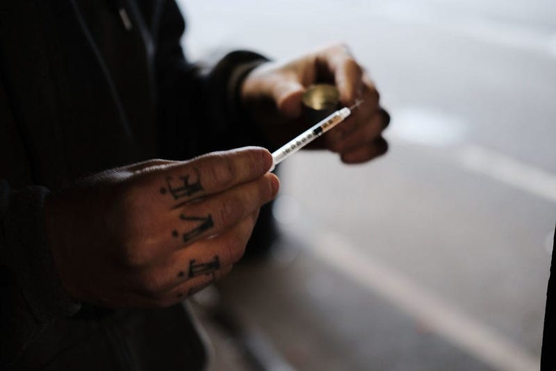 A man uses heroin under a bridge where he lives with other addicts in the Kensington section which has become a hub for heroin use on January 24, 2018 in Philadelphia, Pennsylvania.