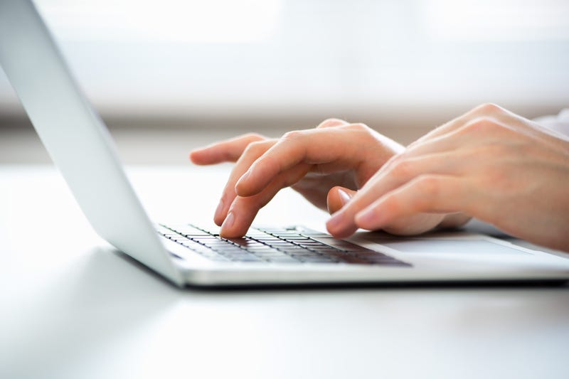 Hands Typing on a Laptop