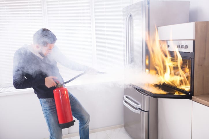 Man Using Fire Extinguisher