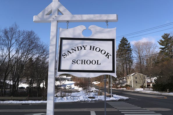 A sign stands near the site of the December 2012 Sandy Hook school shooting