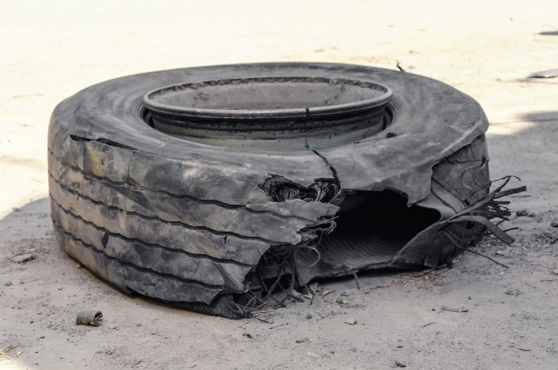 Blown out tire on side of highway
