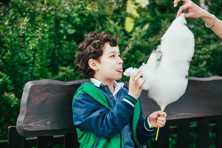 Child eating cotton candy