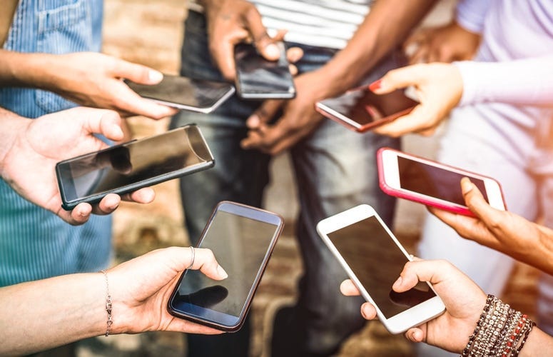 Friends group having addicted fun together using smartphones - Hands detail sharing content on social network with mobile smart phone - Technology concept with people millennials online with cellphone