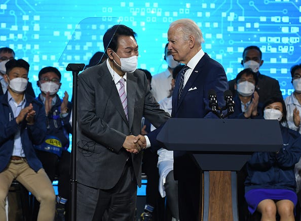 U.S. President Joe Biden shakes hands with South Korean President Yoon Suk-yeol as they visit the Samsung Electronics Pyeongtaek campus on May 20, 2022 in Pyeongtaek, South Korea. President Joe Biden arrived in South Korea on Friday for his first summit with President Yoon Suk-yeol on a range of issues, including North Korea's nuclear program and supply chain risks.