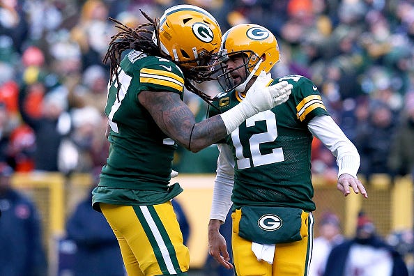 Packers QB Aaron Rodgers bangs heads with OT Billy Turner.