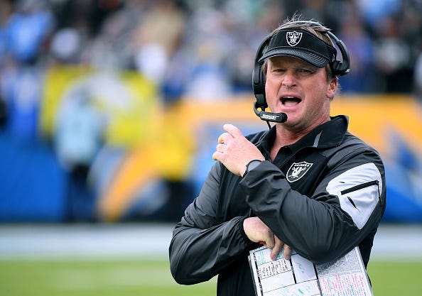 Jon Gruden shouts across the field before a Raiders game.