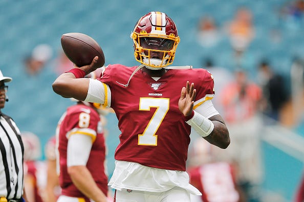 Dwayne Haskins warms up before a game against the Dolphins.
