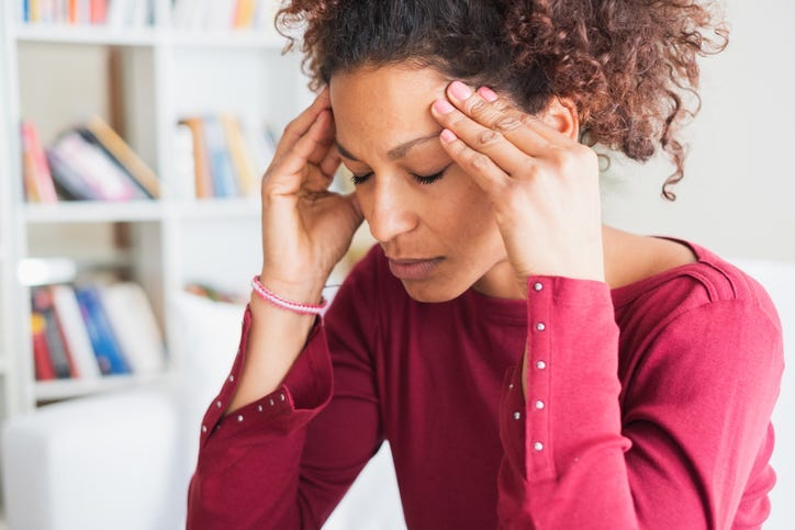 Woman rubbing her temples from headache