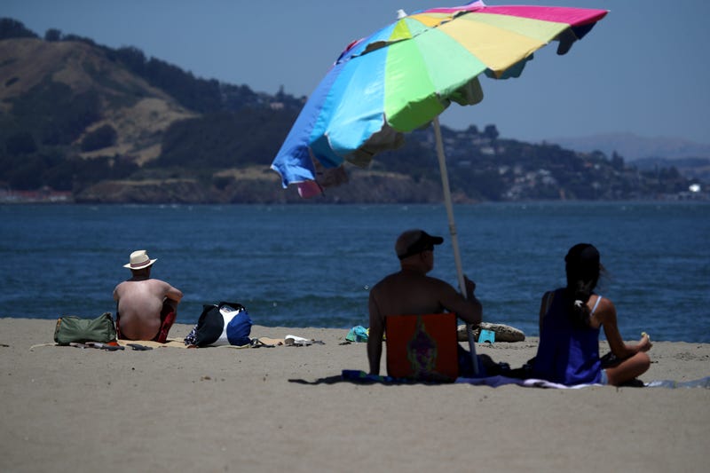People sit on the beach at Crissy Field, June 2019