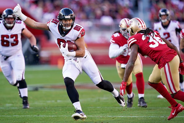 Falcons TE Austin Hooper dekes a defensive back in the open field.