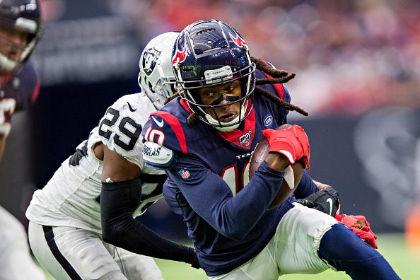 Texans WR DeAndre Hopkins fights for extra yards.