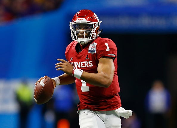 Jalen Hurts eyes a receiver down field during the Peach Bowl.