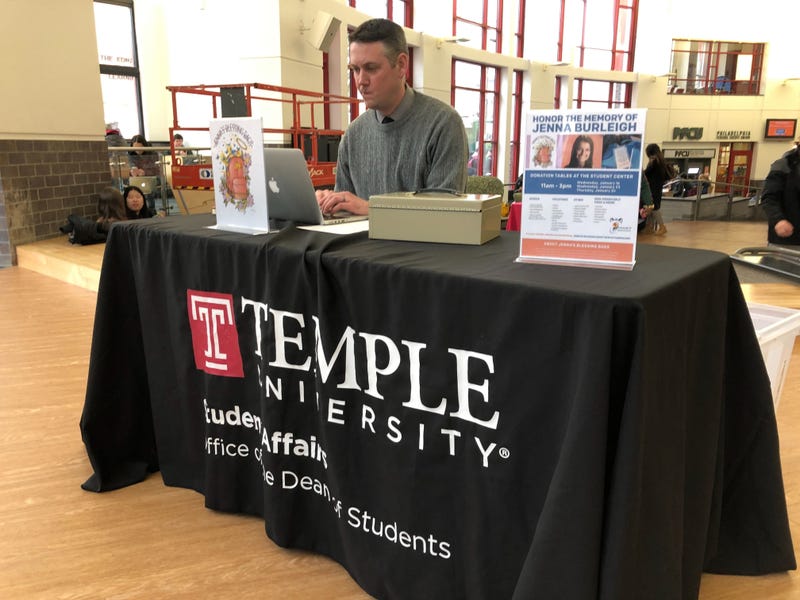 Chris Carey, Senior Associate in the Dean of Students Office, mans the donation booth in Jenna Burleigh's memory, which collects toiletries for the homeless.