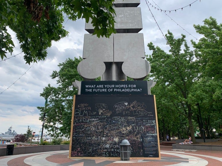 Christopher Columbus monument in Spruce Street Harbor Park with the bottom part boarded up
