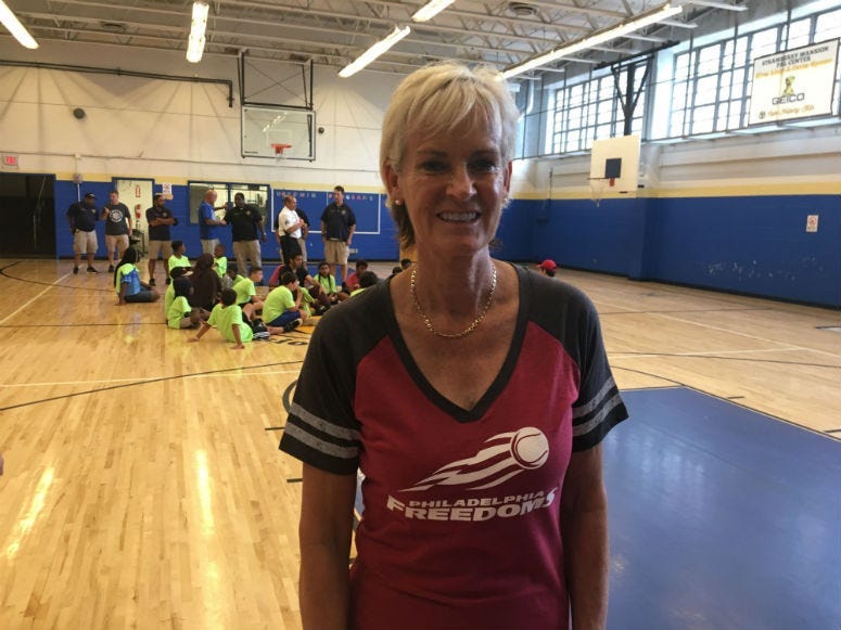 World–renowned tennis coach gives some pointers to kids at Police Athletic League Center.