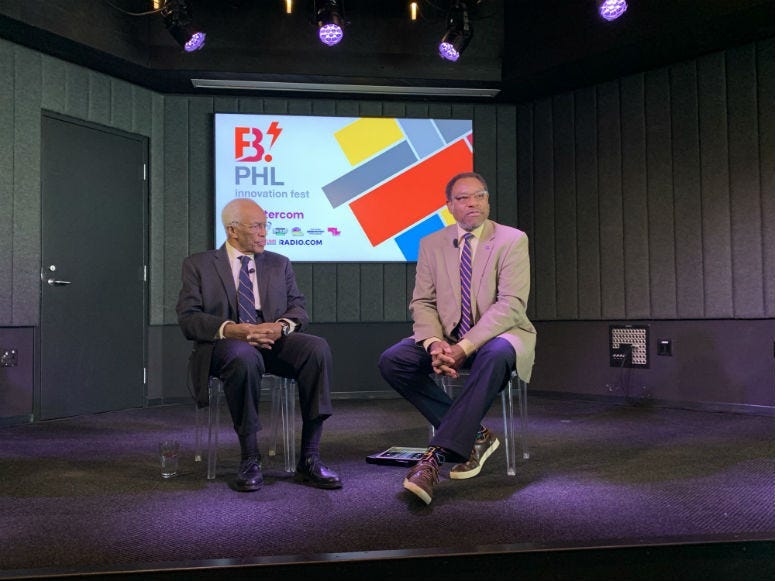 Astronaut Guy Bluford (L) and astronomer Derrick Pitts speaking at a B.PHL event.