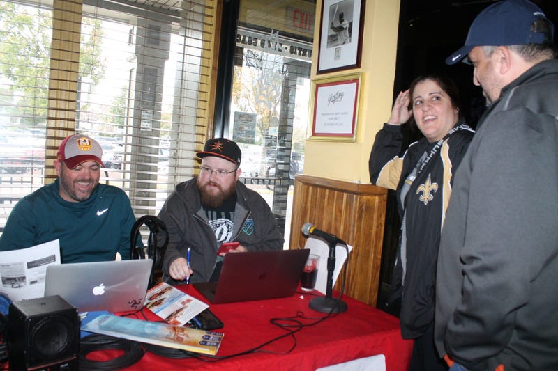 JP and Cakes from The Sports Junkies as well as 106.7 The Fan Street Team, chats with Skins fans at Glory Days Grill in Centreville, Va before kickoff.