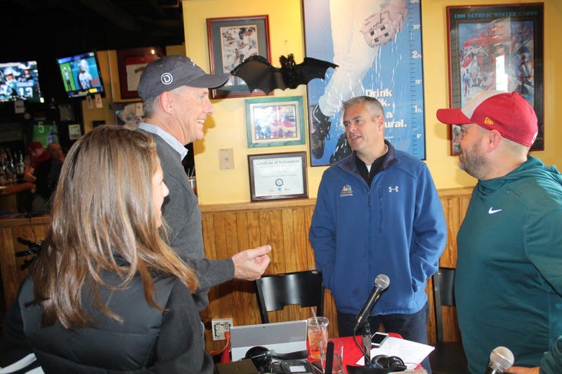 JP and Cakes from The Sports Junkies as well as 106.7 The Fan Street Team, chats with Skins fans at Glory Days Grill in Centreville, Va before kickoff.