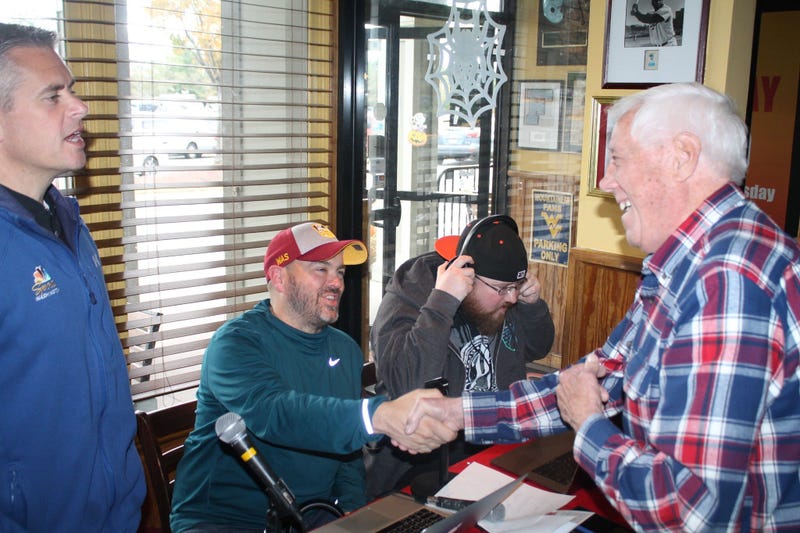 JP and Cakes from The Sports Junkies as well as 106.7 The Fan Street Team, chats with Skins fans at Glory Days Grill in Centreville, Va before kickoff.