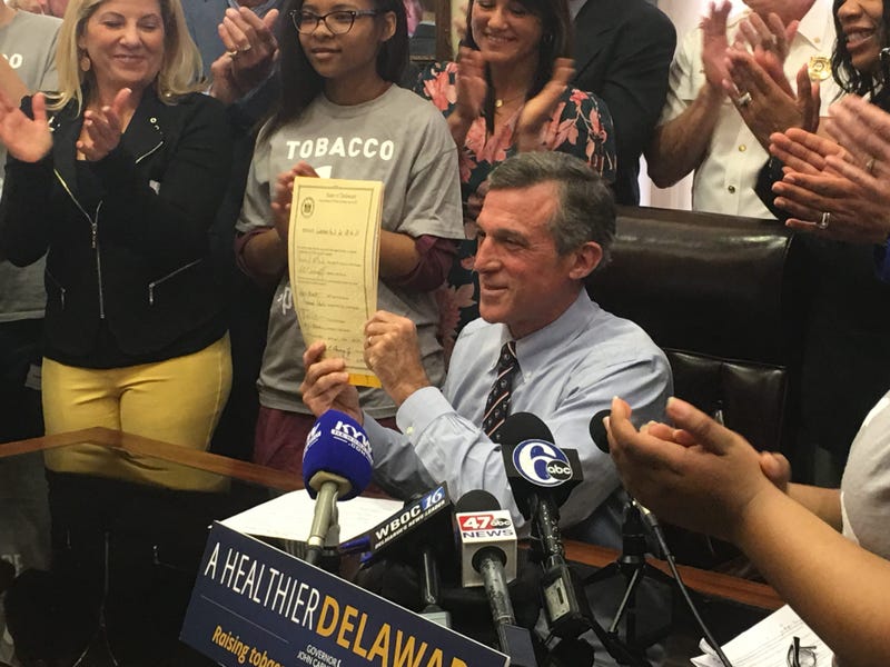 Gov. John Carney signed the bill to raise the legal age from 18 to 21 to purchase cigarettes and tobacco products in Delaware.