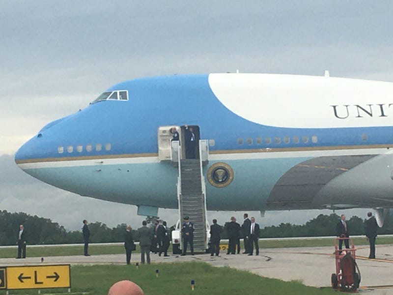 Trump waves to the crowd as he boards Air Force One