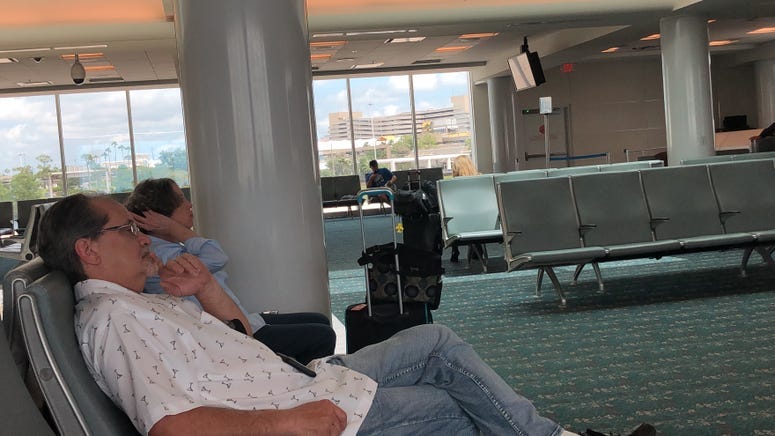 Man Watching CNN in Orlando Airport