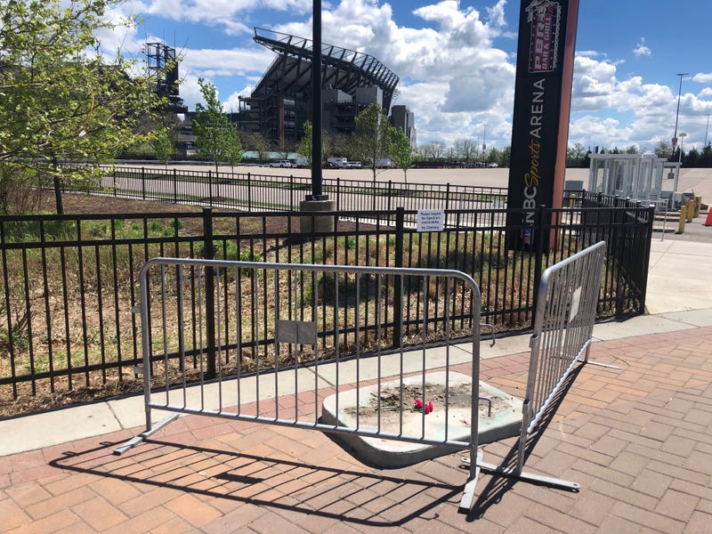 Where the statue of the late singer Kate Smith once stood at the Sports Complex in South Philadelphia there is now an empty spot with three flowers.