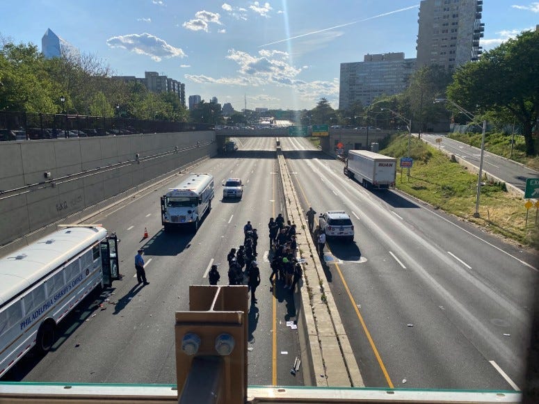 Police officers arresting protesters on the Vine Street Expressway