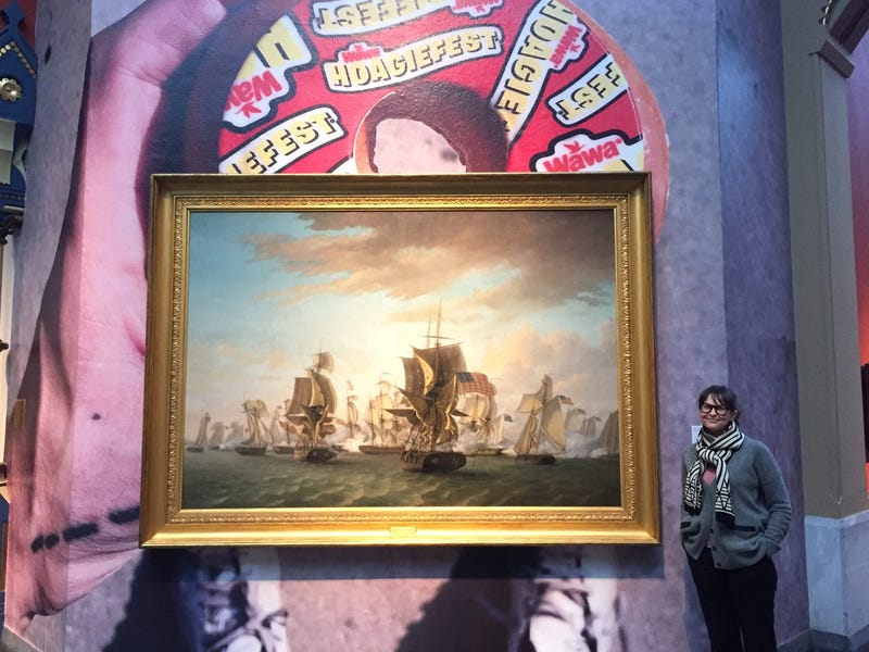 PAFA's Jodie Throckmorton in front of a display from their exhibit, "Ancient History of the Distant Future."