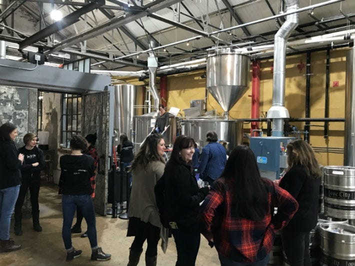 A group of women in pink boots spent their International Women's Day making beer at a brewery in the Callowhill section of Philadelphia in the name of education.