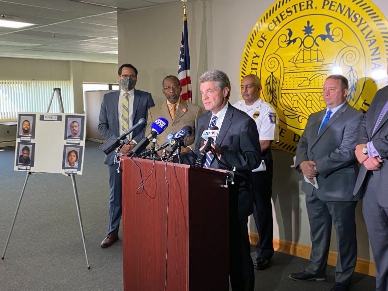 Delaware County DA ack Stollsteimer at the podium at Chester police headquarters