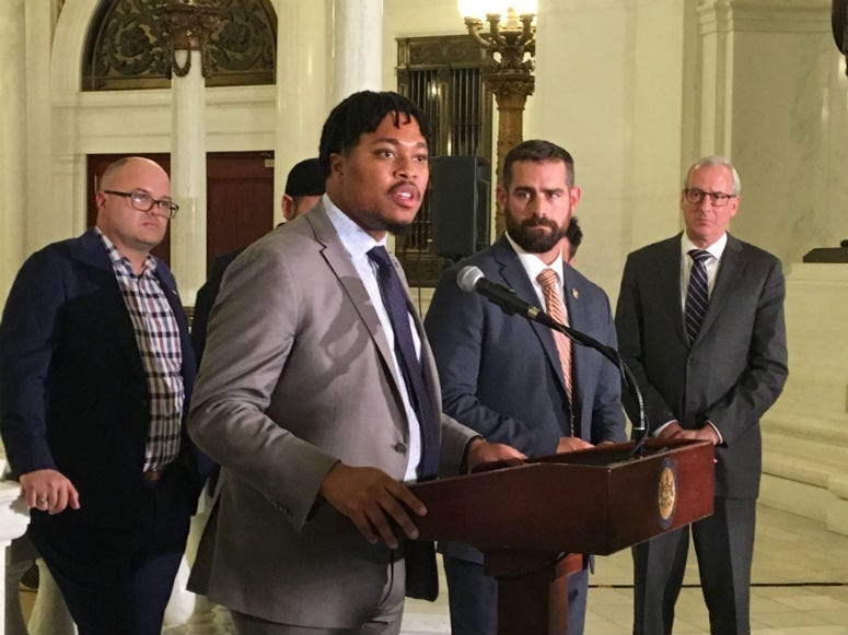 Rep. Malcolm Kenyatta speaks as Rep. Brian Sims (next to him, right) looks on at state Capitol news conference Wednesday.