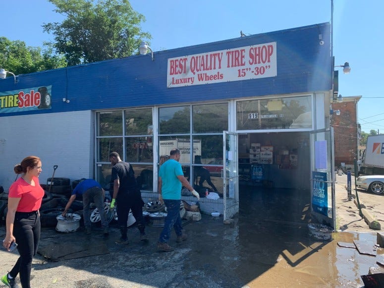 Cleaning up the aftermaths of the flood at Best Quality Tire Shop in Darby