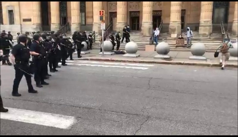 Man pushed to the ground by police officers