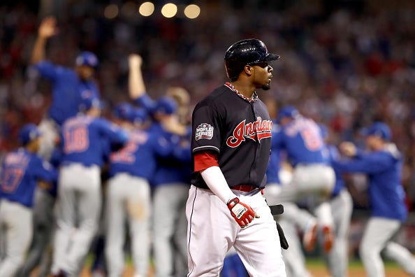 Rajai Davis leaves the field as the Chicago Cubs celebrate the World Series.