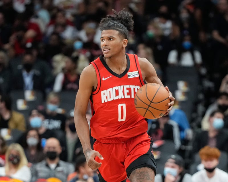 Jalen Green dribbles up court during a Rockets preseason game.