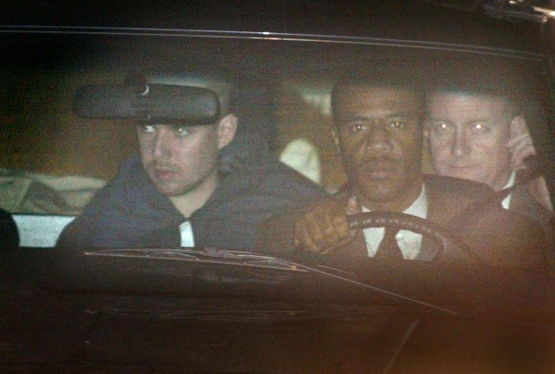 American Taliban fighter John Walker Lindh (L), with his head shaven, is driven from the Alexandria Detention Center to make his first appearance at the federal courthouse a few blocks away January 24, 2002.