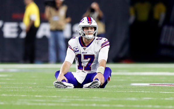 Bills QB Josh Allen watches from the ground after a flag is thrown.