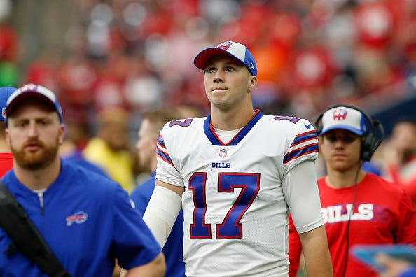 Josh Allen looks up from the Bills sideline.