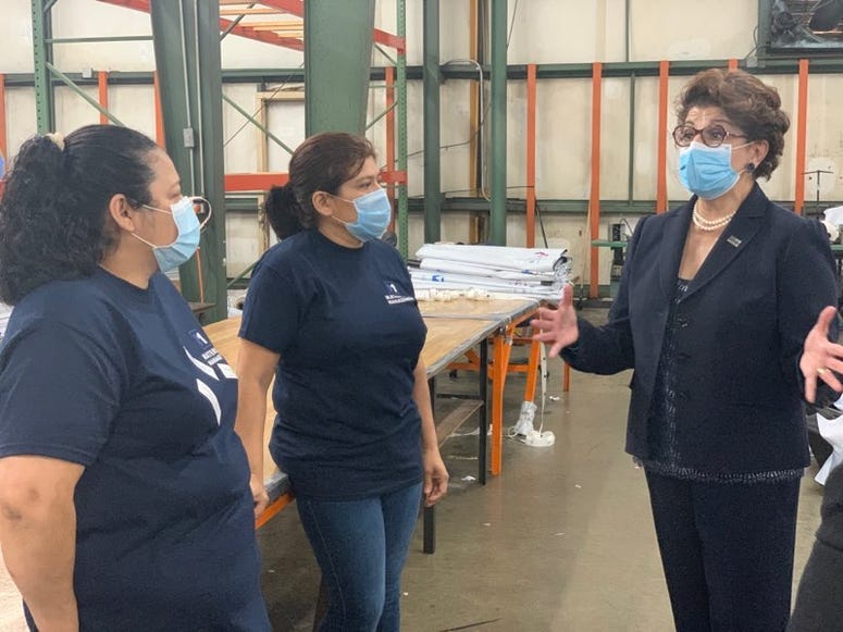 Jovita Carranza speaks to two employees at Daedalus Industrial - Savannah Wilburn