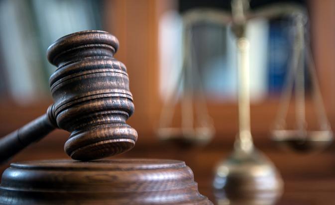 Judge's gavel with scales in the background