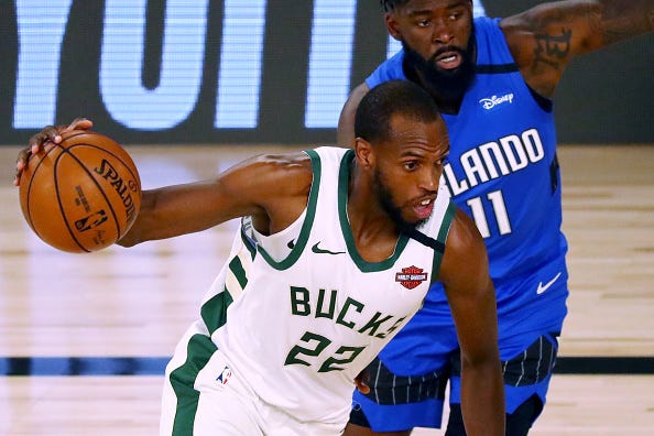 Khris Middleton drives to the hoop during a Bucks game.